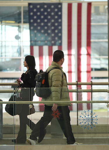 Busy travel day begins with temporary suspension of all American Airlines flights