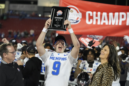 Memphis quarterback Seth Henigan ties AAC record with 104th career touchdown pass near home in Frisco Bowl.