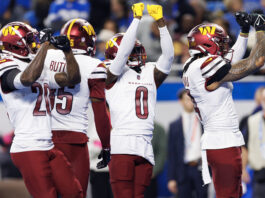 DETROIT, MICHIGAN - JANUARY 18: Cornerback Mike Sainristil #0 of the Washington Commanders celebrates with teammates after an interception during the first half of an NFL football divisional playoff game against the Detroit Lions, at Ford Field on January 18, 2025 in Detroit, Michigan. (Photo by Brooke Sutton/Getty Images)