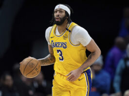 Los Angeles Lakers forward Anthony Davis brings the ball upcourt during the second half of an NBA basketball game against the Charlotte Hornets, Monday, Jan. 27, 2025, in Charlotte, N.C. (AP Photo/Jacob Kupferman)