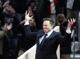 Elon Musk arrives on stage to speak at an indoor Presidential Inauguration parade event in Washington, Monday, Jan. 20, 2025. (AP Photo/Susan Walsh)