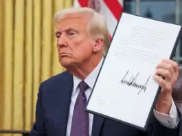 President Donald Trump holds a document on the day he issues executive orders and pardons for Ja. 6 defendants in the Oval Office at the White House in Washington, D.C., on Monday. (Reuters/Carlos Barria)