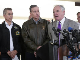 From left, Transportation Secretary Sean Duffy, Sen. Mark Warner, D-Va. and Sen. Tim Kaine, D-Va., and other officials, during a news conference on the Wednesday night crash of an American Airlines jet that collided with an Army helicopter, at Ronald Reagan Washington National Airport, Thursday morning, Jan. 30, 2025, in Arlington, Va. (AP Photo/Mark Schiefelbein)