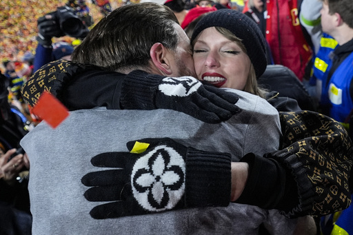 Taylor Swift embraces Kansas City Chiefs tight end Travis Kelce after the AFC Championship NFL football game against the Buffalo Bills, Sunday, Jan. 26, 2025, in Kansas City, Mo. (AP Photo/Ashley Landis)