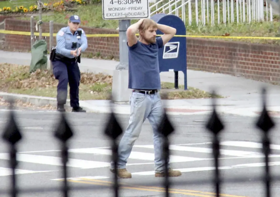 Edgar Maddison Welch, of Salisbury, N.C., is shown surrendering to police, in Washington, D.C., on Dec. 4, 2016. Sathi Soma/AP