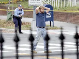 Edgar Maddison Welch, of Salisbury, N.C., is shown surrendering to police, in Washington, D.C., on Dec. 4, 2016. Sathi Soma/AP