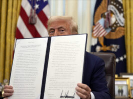 President Donald Trump holds a signed an executive order regarding the declassification and release of records relating to the assassinations of former President John F. Kennedy, Sen. Robert F. Kennedy and Rev. Martin Luther King, Jr., in the Oval Office of the White House, Thursday, Jan. 23, 2025, in Washington. (AP Photo/Ben Curtis)