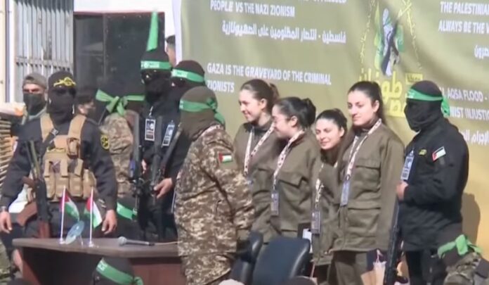 Hamas militants handed over four captive female Israeli soldiers to the Red Cross in Gaza City on Saturday after parading them in front of a crowd (Photo: BBC News/video)