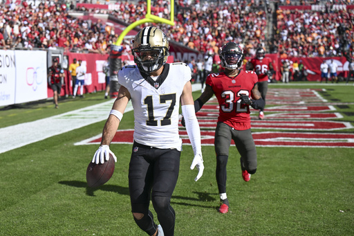 Buccaneers secure NFC South title with 27-19 victory over Saints; Mike Evans exceeds 1,000 receiving yards.