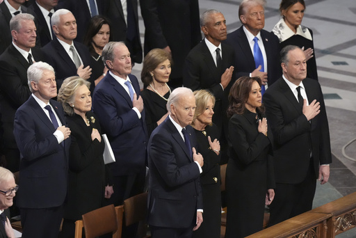 Front row, from left, President Joe Biden, first lady Jill Biden, Vice President Kamala Harris and second gentleman Doug Emhoff and second row from left, former President Bill Clinton, former Secretary of State Hillary Clinton, former President George W. Bush, Laura Bush, former President Barack Obama, President-elect Donald Trump and Melania Trump, stand during the state funeral for former President Jimmy Carter at Washington National Cathedral in Washington, Thursday, Jan. 9, 2025. (AP Photo/Jacquelyn Martin)