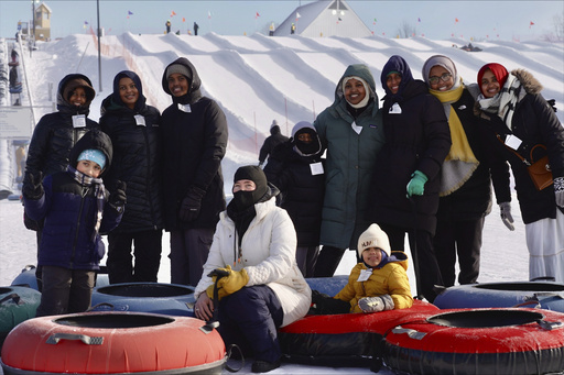 Muslim women’s outdoor club takes on snow tubing in Minnesota, sporting scarves instead of headscarves.