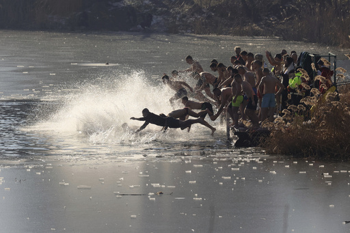 Bulgarians mark Epiphany by performing a traditional dive into freezing waters