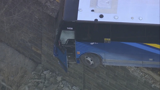 NYC bus front dangles precariously near Bronx overpass following collision