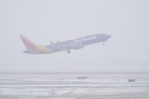 A Southwest Airlines plane takes off in the snow Friday, Jan 10, 2025, in Nashville, Tenn. (AP Photo/George Walker IV)