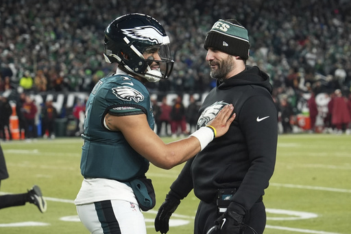 Philadelphia Eagles quarterback Jalen Hurts (1) celebrates with coach Nick Sirianni during the second half of the NFC Championship NFL football game against the Washington Commanders, Sunday, Jan. 26, 2025, in Philadelphia. (AP Photo/Matt Slocum)