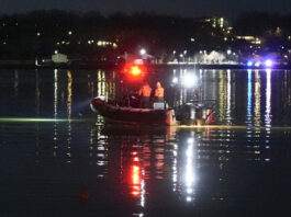 A boat works the scene near Ronald Reagan Washington National Airport, Thursday, Jan. 30, 2025, in Arlington, Va. (AP Photo/Alex Brandon)