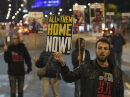 FILE - Israeli protesters call for Hamas to release hostages outside the Ministry of Defense headquarters in Tel Aviv, Israel, on Dec. 17, 2024. (AP Photo/Ariel Schalit, File)