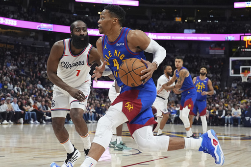 Denver Nuggets guard Russell Westbrook, front, drives to the basket as Los Angeles Clippers guard James Harden defends in the first half of an NBA basketball game Wednesday, Jan. 8, 2025, in Denver. (AP Photo/David Zalubowski)