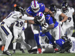 Buffalo Bills running back James Cook (4) carries the ball against the Baltimore Ravens during the fourth quarter of an NFL divisional playoff football game, Sunday, Jan. 19, 2025, in Orchard Park, N.Y. (AP Photo/Adrian Kraus)