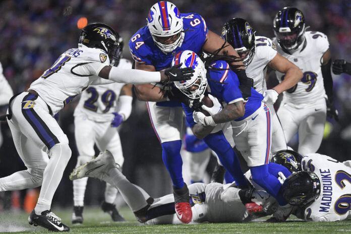 Buffalo Bills running back James Cook (4) carries the ball against the Baltimore Ravens during the fourth quarter of an NFL divisional playoff football game, Sunday, Jan. 19, 2025, in Orchard Park, N.Y. (AP Photo/Adrian Kraus)