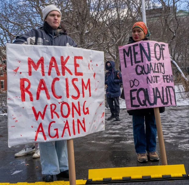 Equality protesters hold signs that reads 'Make Racism Wrong Again' and 'Men of Quality Do Not Fear Equality' after Trump was sworn in
Credit: Alamy