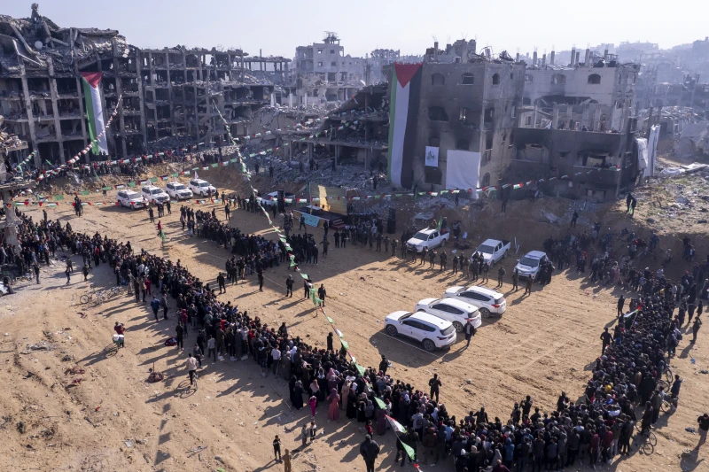 Red Cross vehicles, left, wait for the hand-over of Israeli soldier hostage Agam Berger at the Jabalya refugee camp in Gaza City, Thursday Jan. 30, 2025.(AP Photo/Mohammad Abu Samra)

