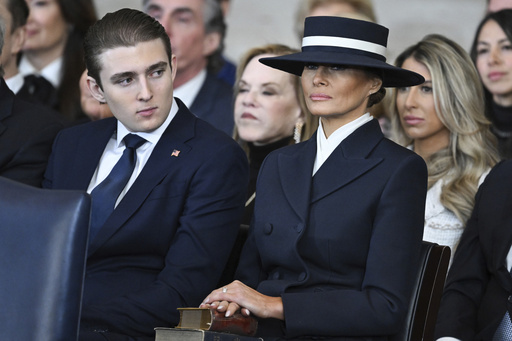 Barron Trump and first lady Melania Trump listen as President Donald Trump delivers remarks after being sworn in during the 60th Presidential Inauguration in the Rotunda of the U.S. Capitol in Washington, Monday, Jan. 20, 2025. (Saul Loeb/Pool photo via AP)