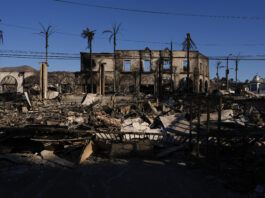 Burned businesses are left behind by the Palisades Fire in the Pacific Palisades neighborhood of Los Angeles, Tuesday, Jan. 14, 2025. (AP Photo/Carolyn Kaster)