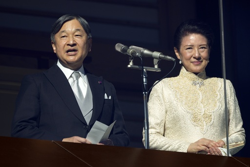 Japanese emperor and family welcome flag-waving public at the palace for New Year celebrations