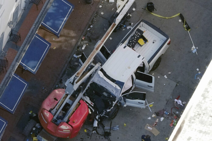 FILE - An Islamic State flag lies on the ground rolled up behind the pickup truck that Shamsud-Din Jabbar drove into a crowd on Bourbon Street in New Orleans on Wednesday, Jan. 1, 2025. (AP Photo/Gerald Herbert, File)