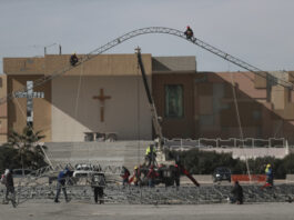 Workers begin the installation of a temporary shelter for possible deportees from the United States, in Ciudad Juarez, Mexico, Wednesday, Jan. 22, 2025. (AP Photo/Christian Chavez)