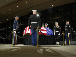 The Guard of Honor surrounds the flag-draped casket of former President Jimmy Carter as he lies in repose at the Jimmy Carter Presidential Library and Museum in Atlanta, Saturday, Jan. 4, 2025. Carter died Dec. 29 at the age of 100. (AP Photo/Alex Brandon, Pool)