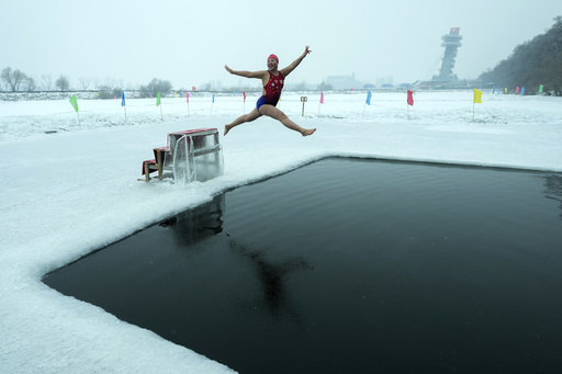 In icy conditions, swimmers in China dive into a river for wellness and enjoyment