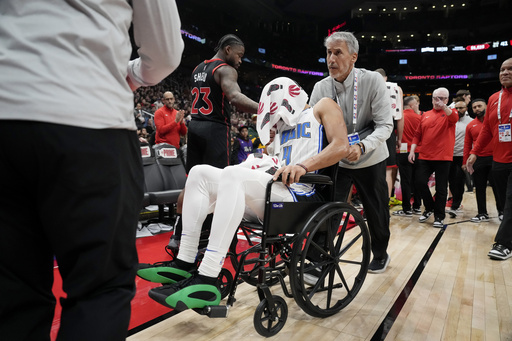 Jalen Suggs of the Magic departs Raptors game in a wheelchair due to back spasms.