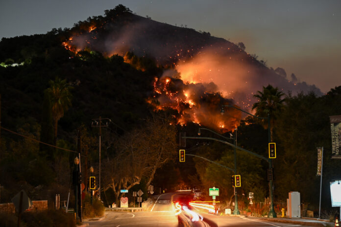 LOS ANGELES, CALIFORNIA - JANUARY 9: A view of flames at the mountain as seen from Topanga Canyon near Pacific Palisades in Topanga, Los Angeles, California, United States on January 9, 2025. A fast-moving wildfire has forced 180,000 people to evacuate, with officials warning that worsening winds could further escalate the blaze. (Photo by Tayfun Coskun/Anadolu via Getty Images)