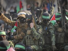 Hamas fighters arrive in a pick-up truck to the site of the hand over of hostage Agam Beger to the Red Cross at the Jabalya refugee camp in Gaza City, Thursday Jan. 30, 2025.(AP Photo/Mohammed Hajjar)