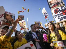 People react as they watch broadcast of the release of Israeli soldier Agam Berger, one of eight hostages set to be released today as part of a ceasefire in the Gaza Strip, in Tel Aviv, Israel, Thursday, Jan. 30, 2025. (AP Photo/Oded Balilty)