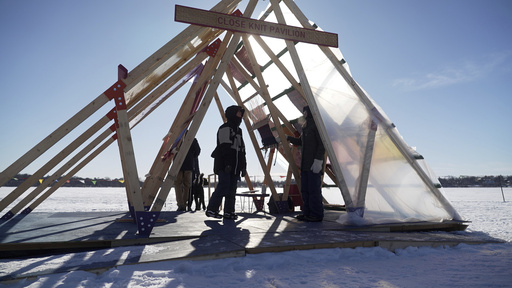 Thousands appreciate art on a frigid Minneapolis lake despite the severe cold.