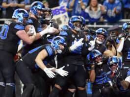 DETROIT,MICHIGAN-JANUARY 5: Detroit Lions teammates celebrate a touchdown with running back Jahmyr Gibbs (26) of the Detroit Lions during a game between the Detroit Lions and the Minnesota Vikings in Detroit, Michigan USA, on Sunday, January 5, 2025. (Photo by Amy Lemus/NurPhoto via Getty Images)