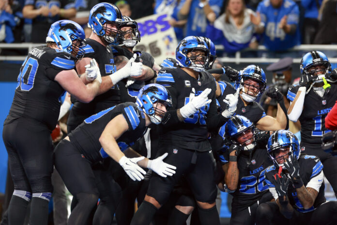 DETROIT,MICHIGAN-JANUARY 5: Detroit Lions teammates celebrate a touchdown with running back Jahmyr Gibbs (26) of the Detroit Lions during a game between the Detroit Lions and the Minnesota Vikings in Detroit, Michigan USA, on Sunday, January 5, 2025. (Photo by Amy Lemus/NurPhoto via Getty Images)