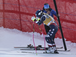 United States' Lindsey Vonn stands up after crashing during an alpine ski, women's World Cup downhill training, in Cortina d'Ampezzo, Italy, Thursday, Jan. 16, 2025. (AP Photo/Marco Trovati)