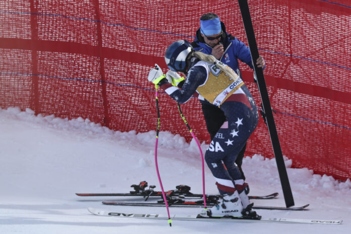 United States' Lindsey Vonn stands up after crashing during an alpine ski, women's World Cup downhill training, in Cortina d'Ampezzo, Italy, Thursday, Jan. 16, 2025. (AP Photo/Marco Trovati)