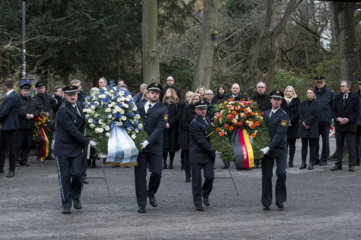 German authorities and community members gather to honor two victims of a knife assault.