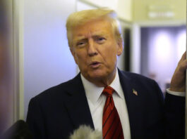 President Donald Trump speaks to reporters aboard Air Force One en route from Miami to Joint Base Andrews, Md., Monday, Jan. 27, 2025. (AP Photo/Mark Schiefelbein)