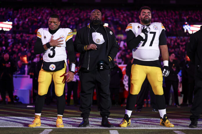 BALTIMORE, MARYLAND - JANUARY 11: Russell Wilson #3, head coach Mike Tomlin, and Cameron Heyward #97 of the Pittsburgh Steelers stand on the sidelines during the national anthem prior to an NFL football wild card playoff game against the Baltimore Ravens at M&T Bank Stadium on January 11, 2025 in Baltimore, Maryland. (Photo by Kevin Sabitus/Getty Images)