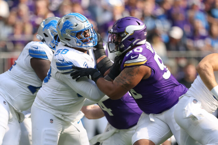 MINNEAPOLIS, MN - OCTOBER 20: Minnesota Vikings defensive end Jonathan Bullard (90) rushes while being blocked by Detroit Lions offensive tackle Penei Sewell (58) during the NFL game between the Detroit Lions and the Minnesota Vikings on October 20, 2024, at U.S. Bank Stadium in Minneapolis, MN. (Photo by Bailey Hillesheim/Icon Sportswire via Getty Images)