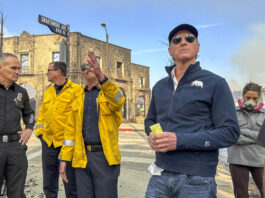 California Governor Gavin Newsom, right, surveys damage in Pacific Palisades with CalFire's Nick Schuler during the Palisades Fire on Wednesday, Jan. 8, 2025, in Pacific Palisades, Calif. (Jeff Gritchen/The Orange County Register via AP)