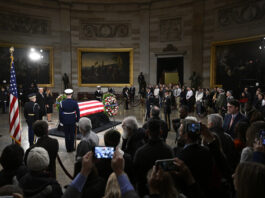 President elect Donald Trump and his wife Melania Trump visit the flag draped casket of the late former President Jimmy Carter as he lies in state at the Rotunda of the U.S. Capitol on Wednesday, Jan. 8, 2025, in Washington. (AP Photo/John McDonnell)