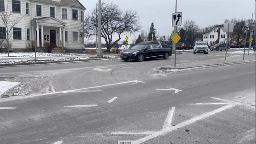 A funeral home in Vermont receives a hearse transporting a deceased US Border Patrol officer, accompanied by an escort.