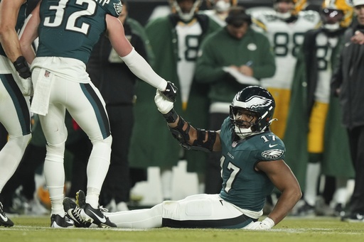 Eagles linebacker Nakobe Dean exits on crutches following left knee injury sustained versus the Packers